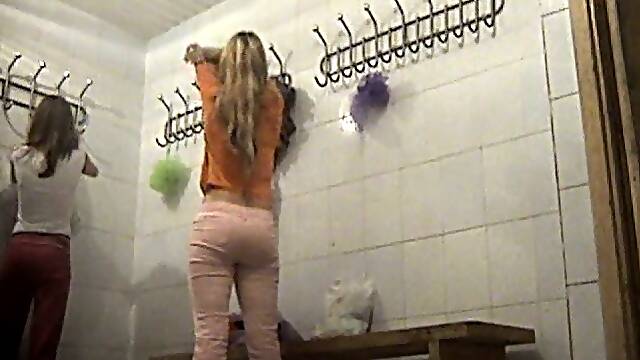 Hot young blonde girl undresses in the locker room on voyeur video