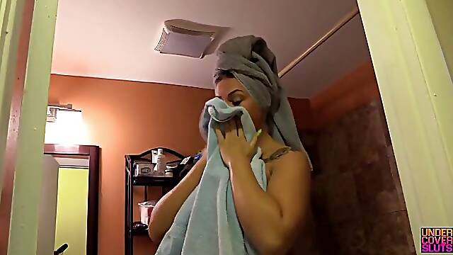 Busty brunette Clover Baltimore plays with her toys after the shower