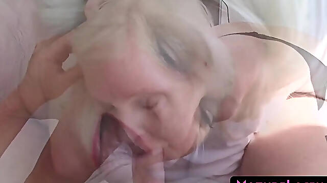 Blonde MILF gives POV blowjob to young man with a large cock