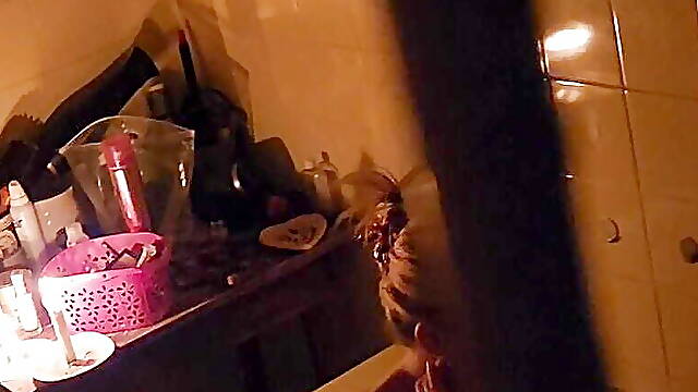 Peeping through my neighbours bathroom window,watch how she plays with her pussy