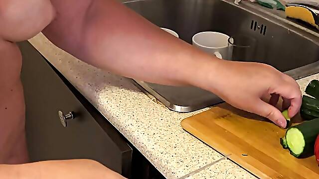Zara is cooking topless in the kitchen