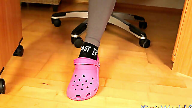 Under Desk Foot Play - Pink Clogs and Worn Socks